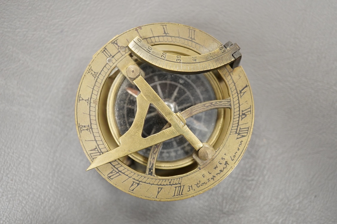 A mid 19th century brass pocket sundial, by F.L. West, 31, Cockspur St., London, with a folding gnomon and latitude scale, 6.5cm diameter